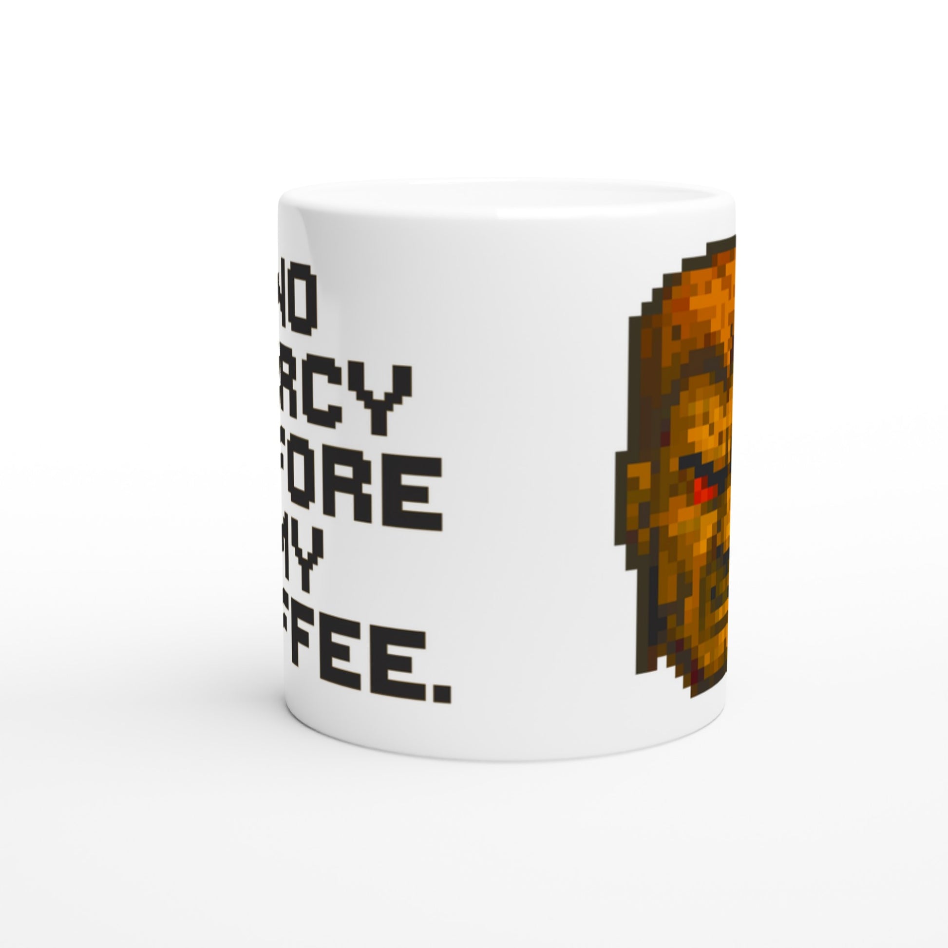 Taza friki No Mercy Before My Coffee 325 ml colocada en mesa o escritorio, diseño pixel art gamer ideal para amantes del café y los videojuegos retro.